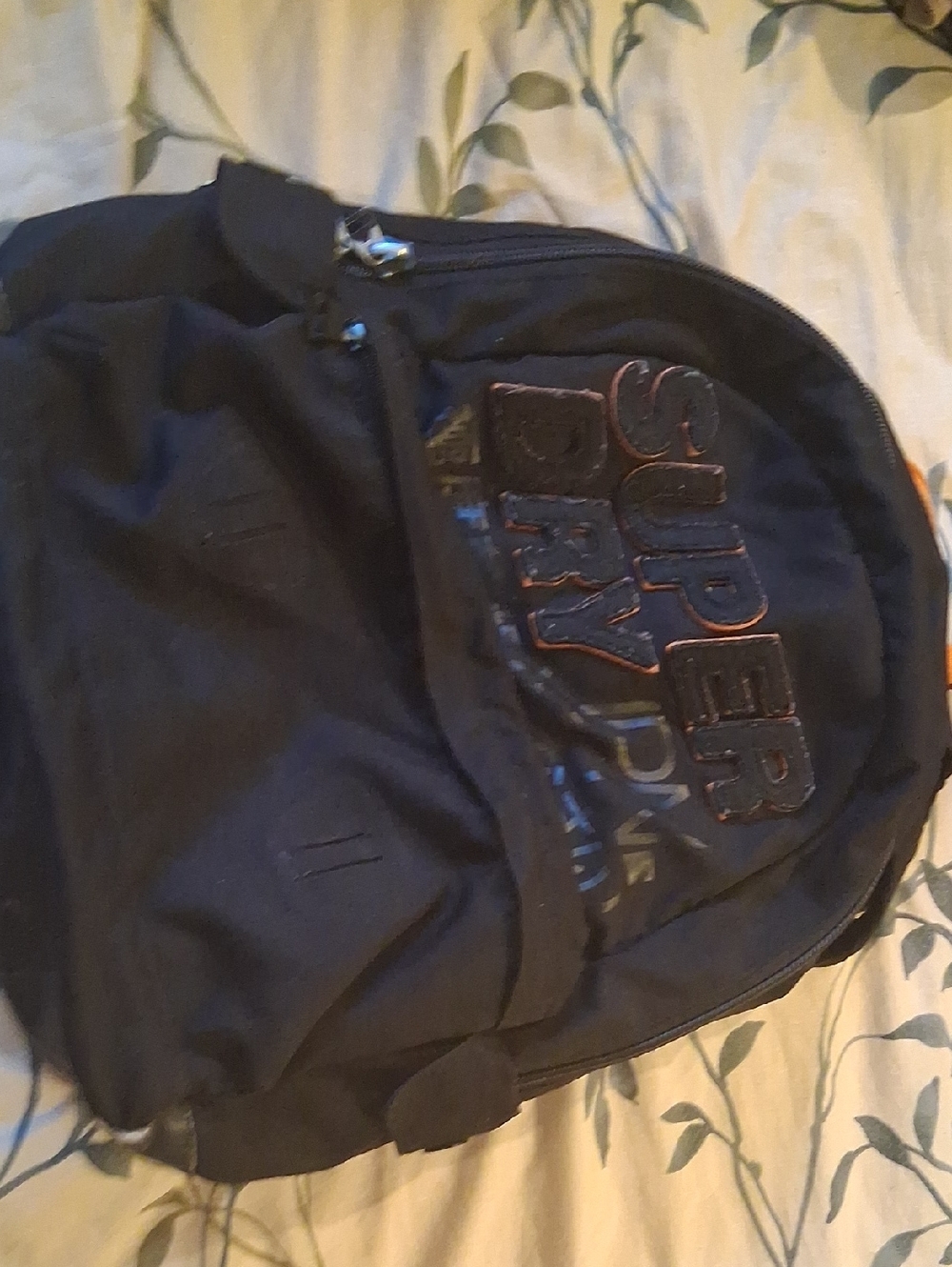 Superdry Black Backpack with Embossed Logo and Subtle Orange Trim